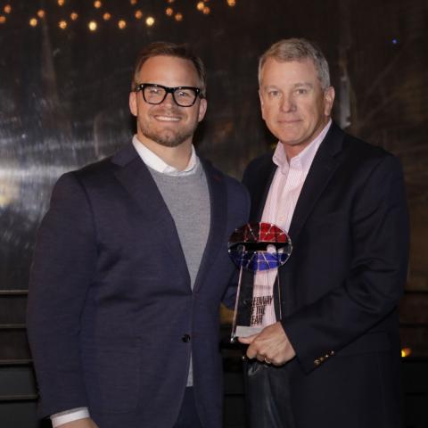 LVMS President Christ Powell (right) accepts the Speedway of the Year award from Speedway Motorsports President and CEO Marcus Smith.