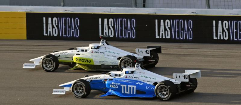 Two autonomous cars make a pass during the Autonomous Challenge at Las Vegas Motor Speedway.