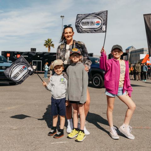 Family poses for photo at LVMS