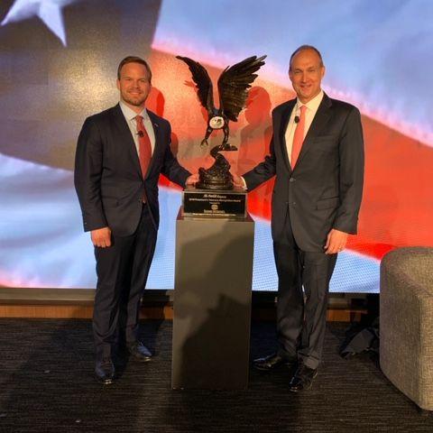 Speedway Motorsports President and CEO Marcus Smith, left, poses with the President’s Veterans Recognition Award alongside Coca-Cola North America President Jim Dinkins.