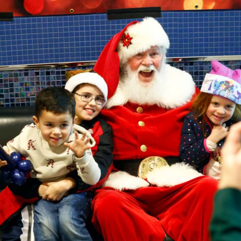 Children taking a picture with Santa