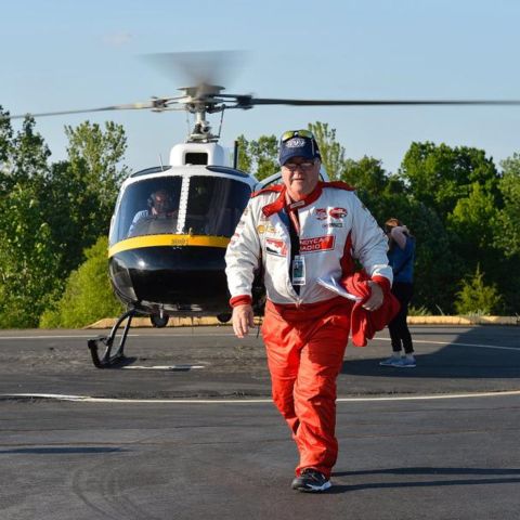 Doug Rice, the only broadcaster to call both the Indianapolis 500 and the Coca-Cola 600 on the same day, exits a helicopter at Charlotte Motor Speedway to head to the booth for the second leg of the “Doug Double,” in 2015.