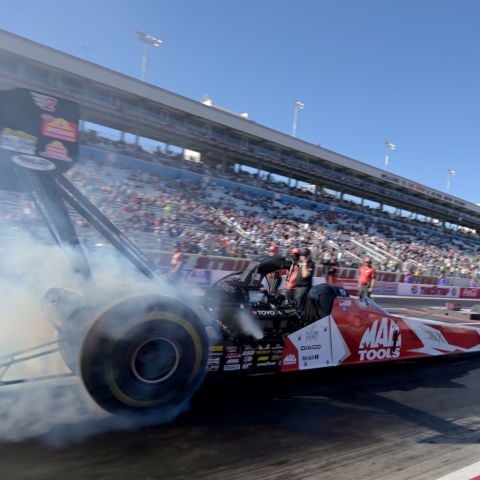 Doug Kalitta warms the tires of his NHRA Top Fuel dragster at The Strip at Las Vegas Motor Speedway