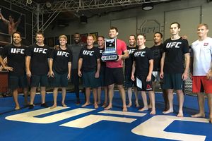 UFC Hall of Famer and DC Solar 350 grand marshal Forrest Griffin poses with the eight NCWTS Chase drivers and the LVMS race trophy at the UFC's TUF Gym on Friday.