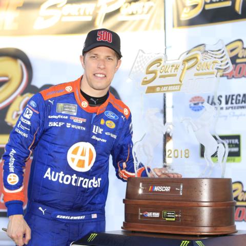 Brad Keselowski poses with the winner's trophy from Sunday's inaugural South Point 400 MENCS Playoffs race.