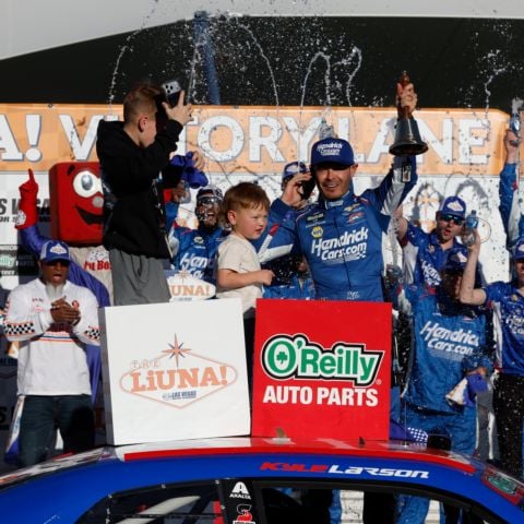 Kyle Larson celebrates his victory in The LiUNA NASCAR O'Reilly Auto Parts Series race at Las Vegas Motor Speedway with his son, Owen, and his crew.
