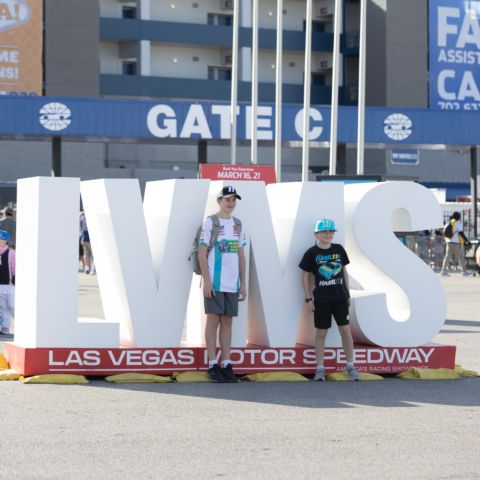 Kids Pose in front of LVMS sign